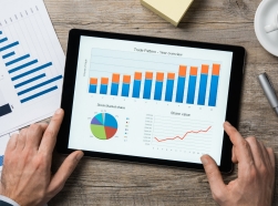 A set of financial graphs viewed on a tablet