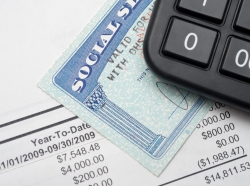 A calculator, social security card and financial document.
