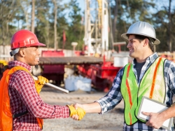 Workers greeting each other at a drilling site