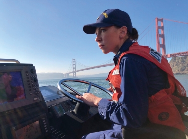 Petty Officer 1st Class Krystyna Duffy, a boatswain's mate assigned to Coast Guard Station Golden Gate in San Francisco, drives a 47-foot Motor Lifeboat near the Golden Gate Bridge, February 8, 2018, photo by PO3 Sarah Wi/U.S. Coast Guard