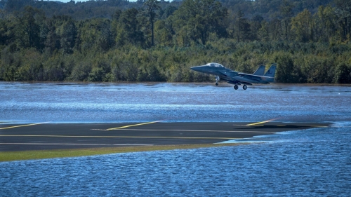 An airplane takes off from a flooded runway after Hurricane Matthew.