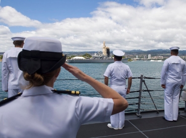 U.S. Navy Sailors salute during an approach to a port in Hawaii