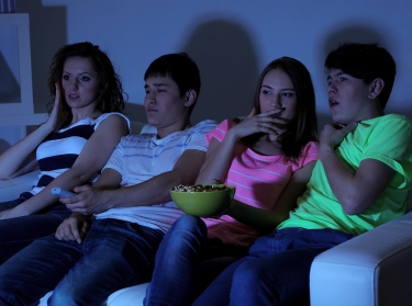 Group of teenagers watching TV