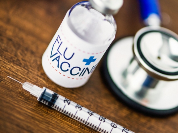 Flu vaccine, syringe, and stethoscope