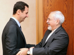 Syria's President Bashar al-Assad welcomes Iran's Foreign Minister Mohammad Javad Zarif before a meeting in Damascus January 15, 2014
