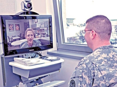 A soldier speaks to another soldier via webcam