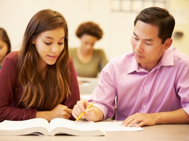 A high school student gets instruction from her teacher