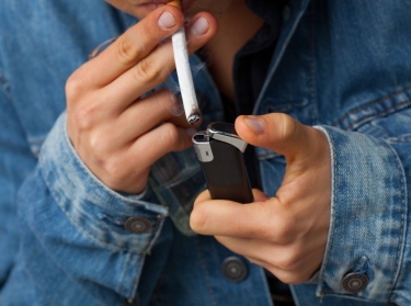 Man with a lighter and cigarette