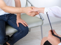 A patient and counseling professional shake hands