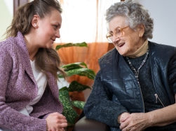 A young woman cares for her elderly grandmother