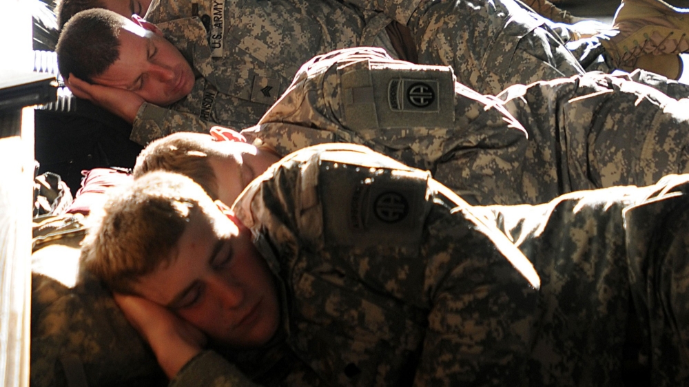 Soldiers try to sleep during the day