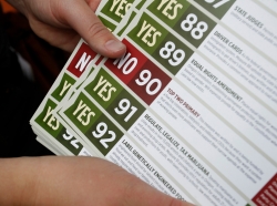 Canvassers leave flyers to drum up support for Oregon's Measure 91, which would legalize recreational marijuana use, in Portland, October 28, 2014