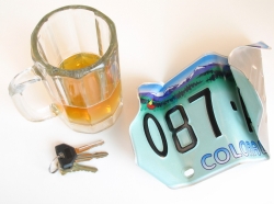 Glass of beer, car keys, and crumpled Colorado license plate