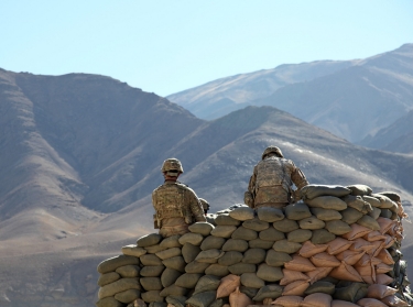 Two U.S. soldiers run communications equipment from a bunker in Wardak province, Afghanistan, January 9, 2011