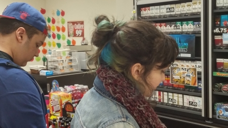 Two teenagers at a convenience store counter