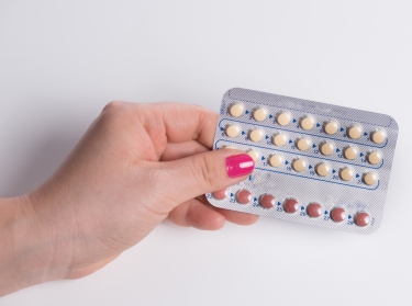 A hand holding contraceptive pills 