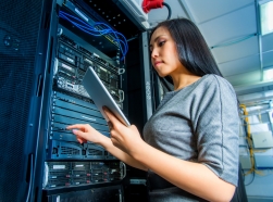 A female systems engineer working on a computer server