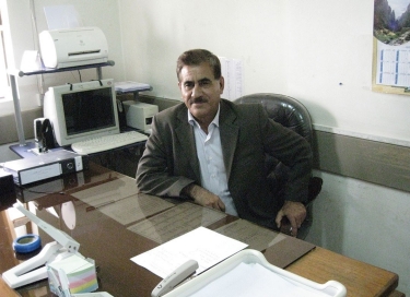 A doctor sits at his desk