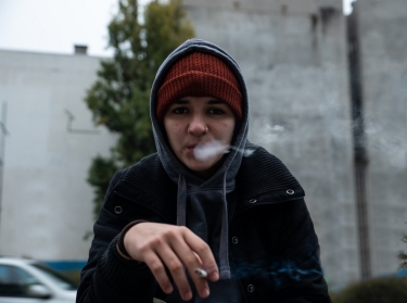Teenage girl smoking on the street, photo by Srdjanns74/Getty Images
