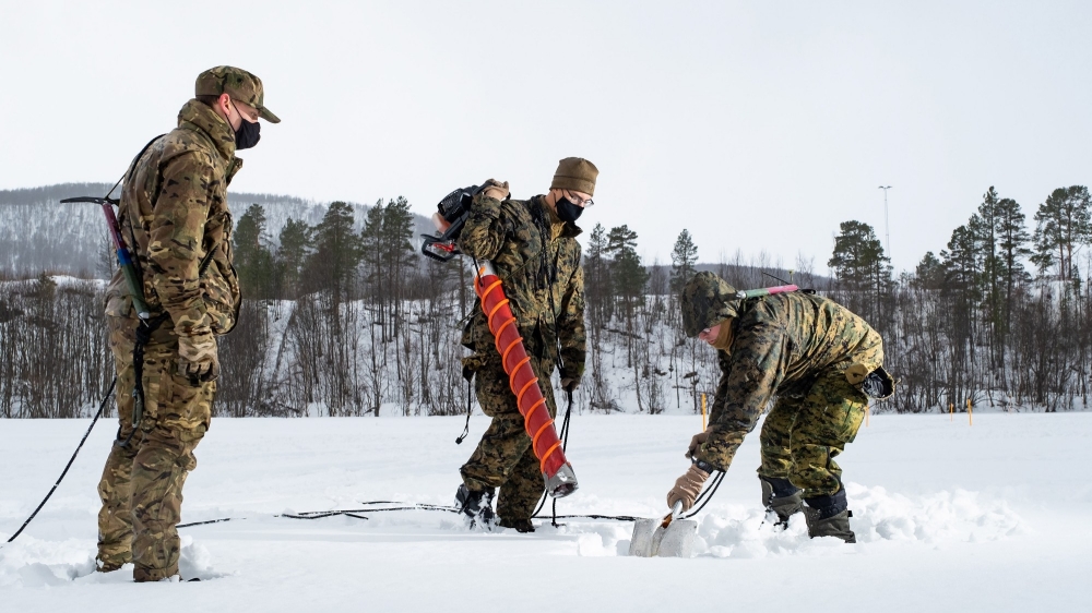 Gloves, Face Covering, Face Mask, Personal Protective Equipment, Clothing, Equipment, Army, United States Marine Corps, Drilling, Action, ice auger drill, 24 Commando Royal Engineers, 3 Commando Brigade, Arctic, cold weather survival course, Europe, High North, ice survey, norway, Royal Engineers, Royal Marine Exercise, Royal Marine Unit, Royal Marines, Royal Navy, Snow, USMC, WD21, Winter Deployment 21, Winter Warriors, International Training, Survival Training, Cold Weather Training, Arctic Survival Training, Training, Ice, Sample, NATO, Multinational, Interoperability, Partnering