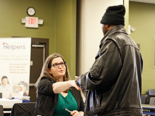 Two people shake hands at a job fair in Clarksville, Tennessee, March 6, 2020