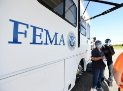 FEMA staff at a mobile center assist residents with registration and answer questions about disaster-assistance programs in the aftermath of Hurricane Sally, September 2020, photo by FEMA