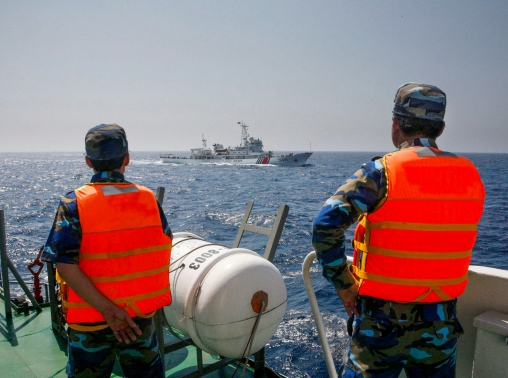 Officers of the Vietnamese Marine Guard monitor a Chinese coast guard vessel in the South China Sea, about 130 miles offshore of Vietnam, May 15, 2014