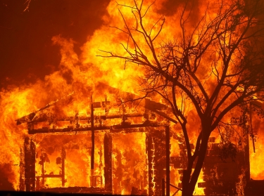 A house burning along Cherry Glen Road during the LNU Lightning Complex Fire on the outskirts of Vacaville, California, August 19, 2020, photo by Stephen Lam/Reuters