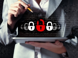 An information security illustration superimposed over a businesswoman holding a tablet