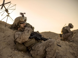 Marine Corps sergeant relays commands during a tactical exercise to recover aircraft and personnel at an undisclosed location in Southwest Asia, January 25, 2016