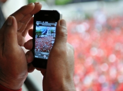 A smartphone is used to photograph a Red Shirt rally in Bangkok, Thailand