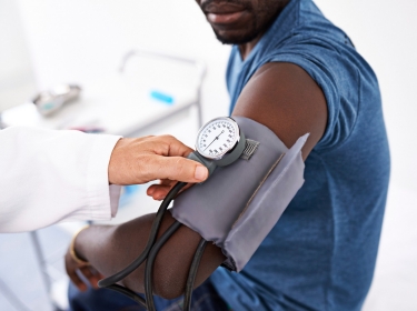 Doctor taking blood pressure of an African-American man