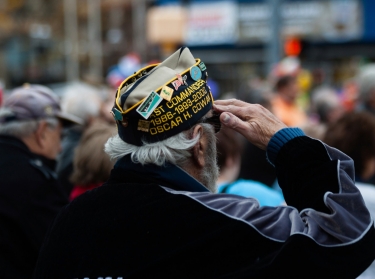Stamford, USA - November 10, 2013: A Veteran is enjoying and observing the Veterans Day Parade honoring all the Veterans from the Korean, Vietnam and other wars. 
