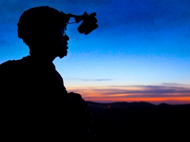 A U.S. soldier provides overwatch security atop a mountain at Paktika province, Afghanistan, May 25, 2011