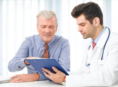 Older man consulting with male doctor
