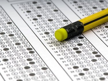 A multiple-choice examination sheet and a pencil eraser