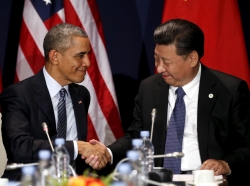 U.S. President Barack Obama shakes hands with Chinese President Xi Jinping at the start of the climate summit in Paris, November 30, 2015