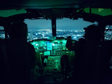 Two U.S. Air Force pilots use night vision goggles during an exercise above Yokota Air Base, Japan, August 24, 2015