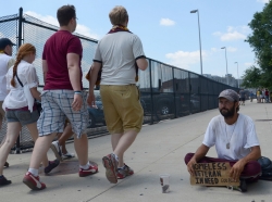 People walking past homeless veteran in Detroit, MI