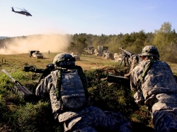 Supply sergeants for the 2nd Cavalry Regiment's field artillery troop defend a hilltop as a 16th Sustainment Brigade logistics supply column passes by during exercise Saber Junction 15