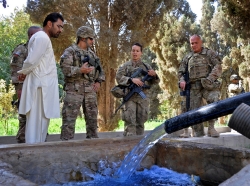Key Leader Engagement attendees observe a solar-powered water pump while discussing ongoing projects in Farah province, Afghanistan, September 28, 2013