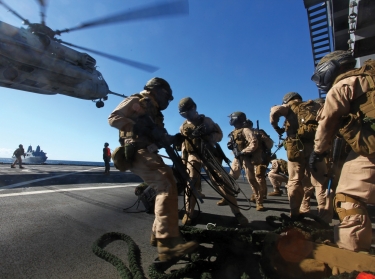 U.S. Marines storm aboard MSC dry cargo/ammunition ship USNS Laramie during a visit, board, search, and seizure exercise