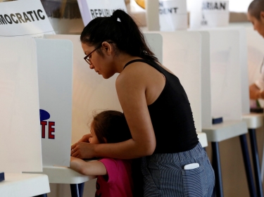 First-time voter Brianna Macias votes at Assumption Church during the U.S. presidential primary election, June 7, 2016