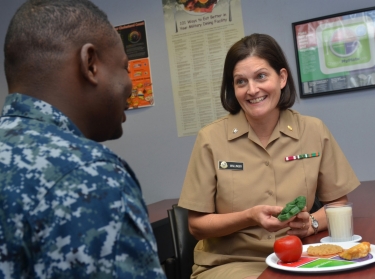 Cmdr. Jennifer Wallinger, a dietitian at Naval Hospital Jacksonville, recommends healthy food and beverage choices to a patient, December 9, 2016