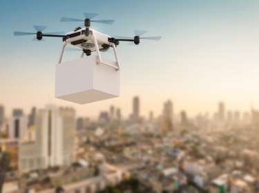 A delivery drone flying over a city