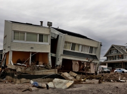 The remains of houses destroyed during Hurricane Sandy are seen in the Rockaways area of New York's borough of Queens, January 14, 2013