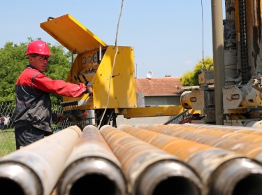 An oil and gas worker operates a drilling rig
