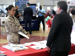 A drill instructor talks to a representative from the FBI to seek information about employment opportunities during a career and education fair at the Marine Corps Recruit Depot, Parris Island, April 16, 2013