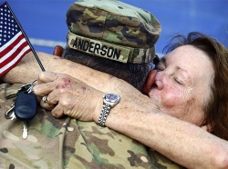 An Army National Guardsman embraces a loved one upon returning to Virginia, July 10, 2017, from a deployment to the Middle East supporting Task Force Spartan Shield.