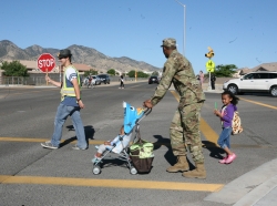 An officer walking his children to school and daycare on Bike and Walk to School and Work Day at Fort Huachuca, Arizona, May 4, 2016